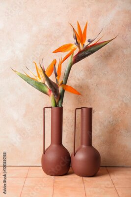 Papier peint  Vases with beautiful strelitzia flowers on beige tile table