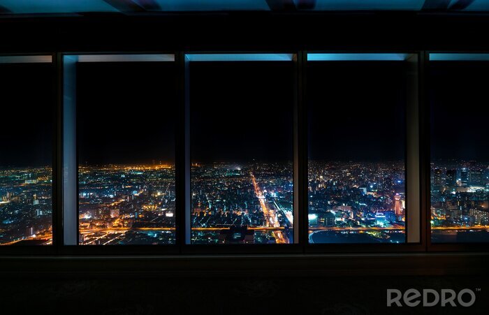 Poster  Aerial view of the Osaka skyline at night through a skyscraper window