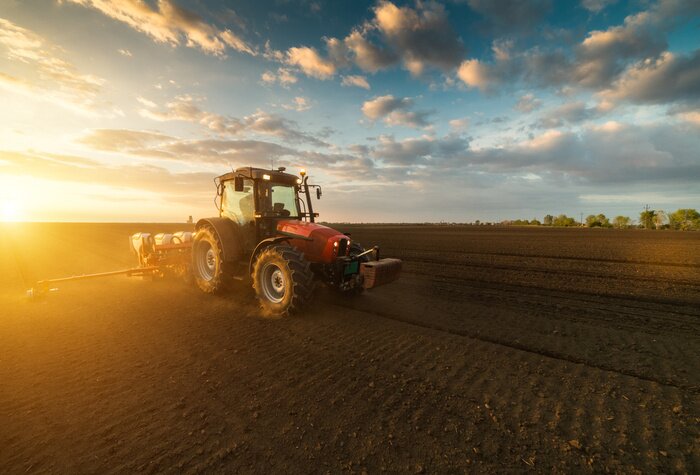 Poster  Agriculteur avec semoir de tracteur - semer des cultures au champ agricole au printemps