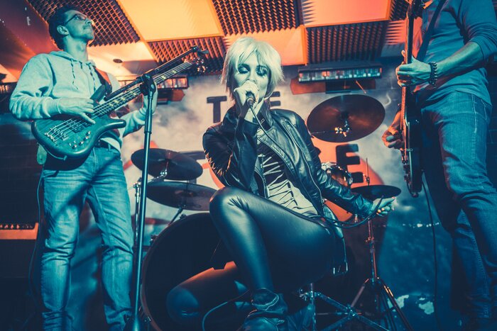 Poster  Band playing on stage making music together