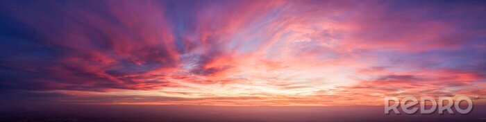 Poster  Beautiful dark orange sky evening beauty and Clouds at sunset , dawn, the rays of the sun break through the clouds. Natural