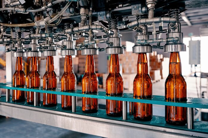 Poster  Beer bottles filling on the conveyor belt in the brewery factory