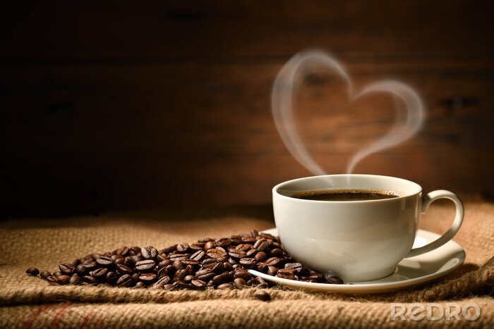 Poster  Cup of coffee with heart shape smoke and coffee beans on burlap sack on old wooden background