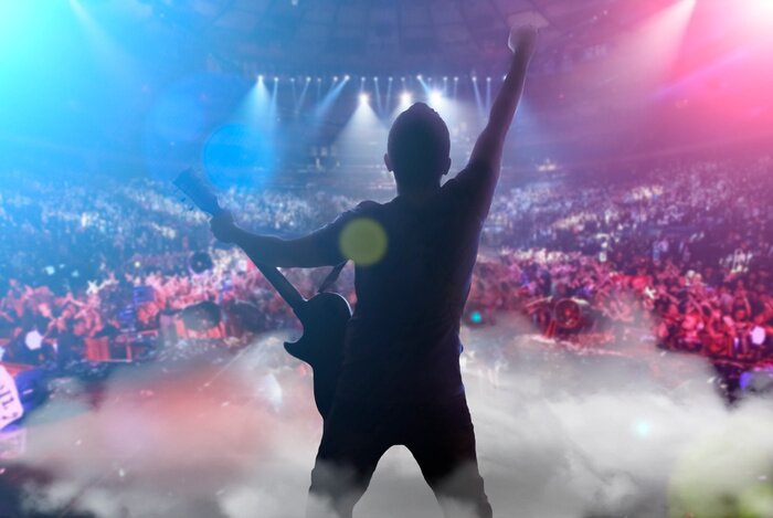 Poster  guy on stage with a guitar playing a concert