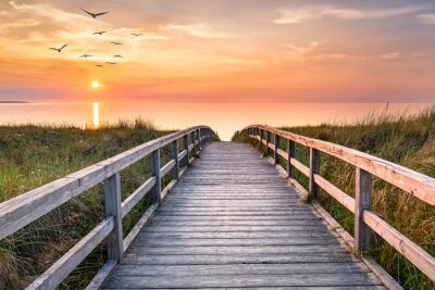Papier peint  Jetée vers la mer au lever du soleil