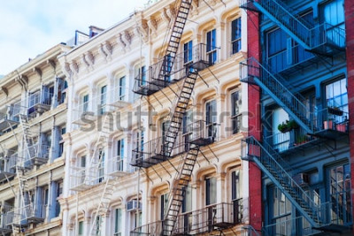 Poster  Old residential buildings with fire escape stairs in Soho, New York City