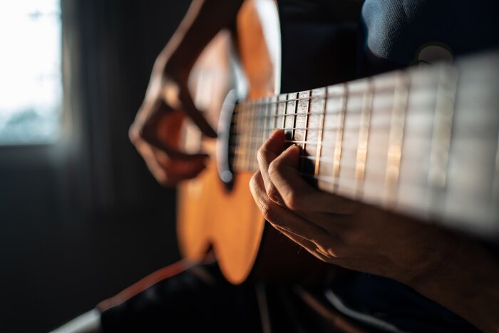 Poster  Performing Classical Guitar. Focus on left hand