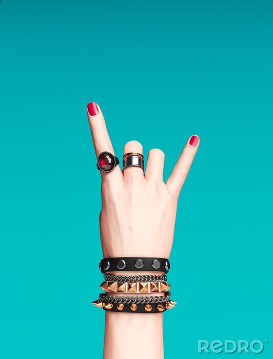 Poster  Rock hand sign, female hand punk rock gesture with gold wrist bracelets and finger rings isolated, creative art protest banner, fashion hipster accessories, 3d rendering