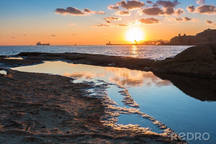 Poster  Rocky coastline of Malta and Mediterranean Sea at sunrise
