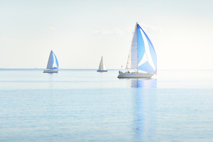 Poster  Sailing yacht regatta. Modern sailboats racing with blue spinnaker sails. Clear summer day. Kiel, Germany. Sport and recreation, transportation, private wessel, vacations