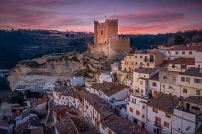 Sunset aerial panorama view of Alcala del Jucar medieval historic village with white washed houses and a castle on a rock in Albacete Spain