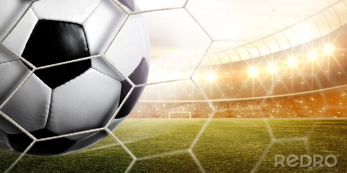 Poster  Un ballon de football dans un stade ensoleillé