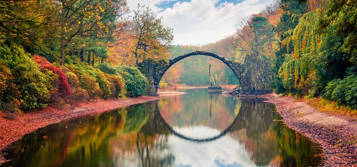 Poster  Unbelievable morning scene of Azalea and Rhododendron Park Kromlau, Germany, Europe. Great autumn panorama of Rakotz Bridge (Rakotzbrucke, Devil's Bridge). Traveling concept background.