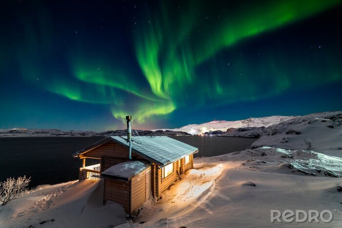 Poster  Wooden cottage on the background of the Northern Lights at night.