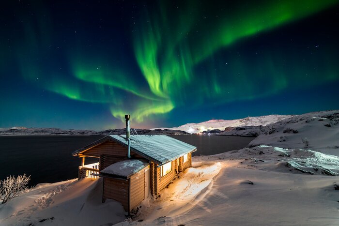 Poster  Wooden cottage on the background of the Northern Lights at night.