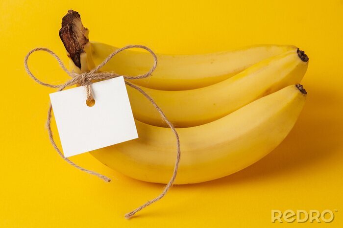 Sticker  Bananes attachées avec une ficelle sur fond jaune