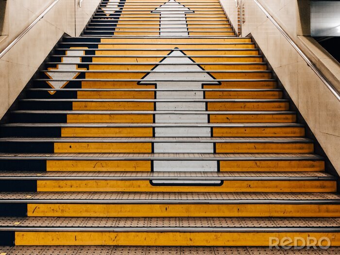 Sticker  Big arrows direction symbol on concret stair in subway in Japan. there is seperate the walk way clearly. Line up and down.