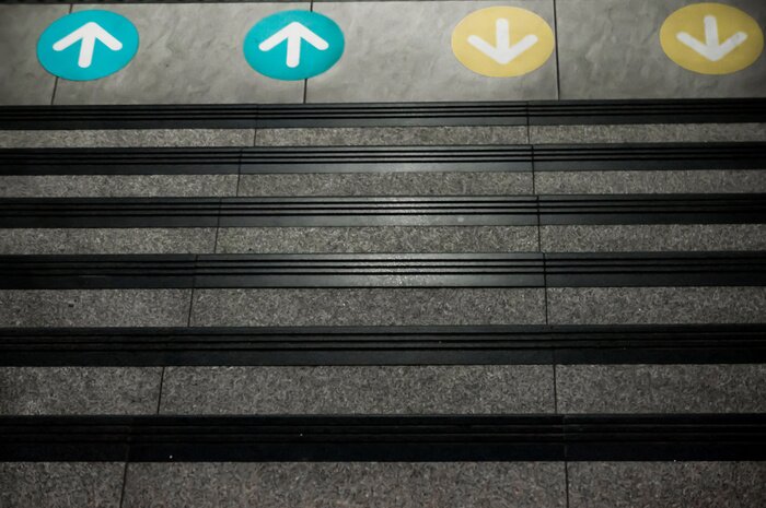 Sticker  Colored Arrow Signs Sticker Placed on The Floor in front of Stairs