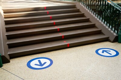 Sticker  Epidemic protection measures in shops, shopping malls or centres floor blue circle stickers with arrow . Social Distance Shopping. Life after virus. Secure marking of lines on floor for directions,