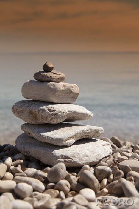Sticker  Stack of stones, Zen concept, on sandy beach