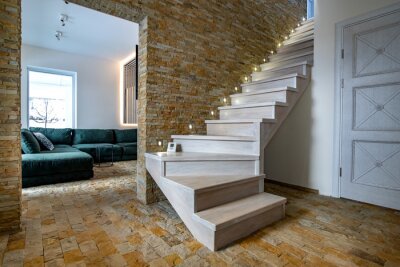 Sticker  Stylish wooden contemporary staircase inside loft house interior. Modern hallway with decorative limestone brick walls and white oak stairs.