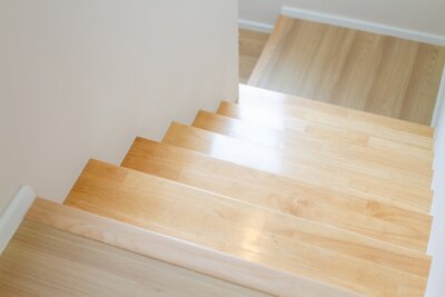 Sticker  The design of staircase inside the house are paved with light brown wood laminate.