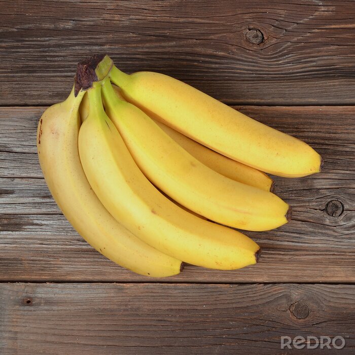 Sticker  Un régime de bananes sur une surface en bois