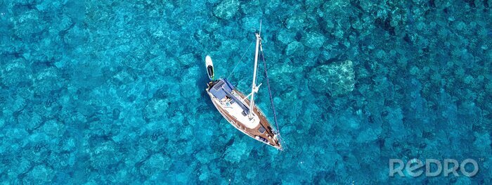 Tableau  Aerial drone photo of luxury sail boat docked in tropical exotic bay with turquoise crystal clear sea