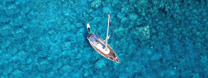 Tableau  Aerial drone photo of luxury sail boat docked in tropical exotic bay with turquoise crystal clear sea