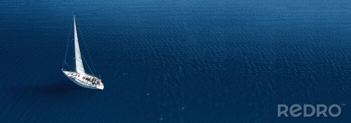 Tableau  Aerial drone ultra wide photo of beautiful sail boat cruising in Aegean deep blue sea