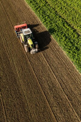 Tableau  aerial view of the tractor on the harvest field