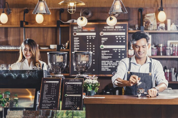 Tableau  Asian Barista preparing cup of coffee, espresso with latte or cappuccino for customer order in coffee shop,bartender pouring milk,Small business owner and startup in coffee shop and restaurant concept