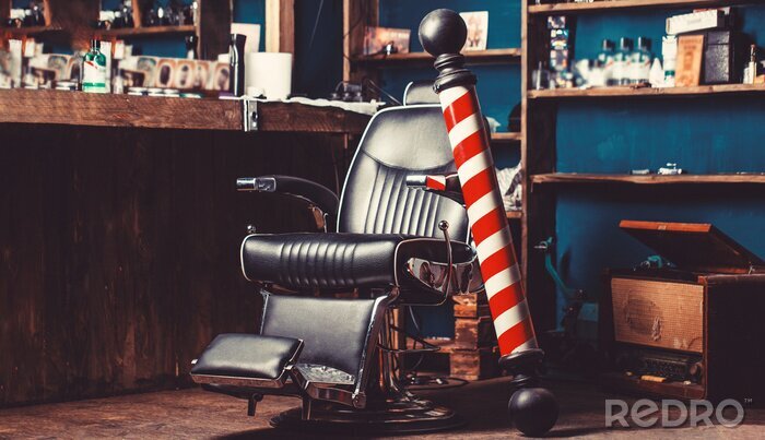 Tableau  Barber shop pole. Logo of the barbershop, symbol. Stylish vintage barber chair. Hairstylist in barbershop interior. Barber shop chair. Barbershop armchair, hairdresser, hair salon, barber shop for men