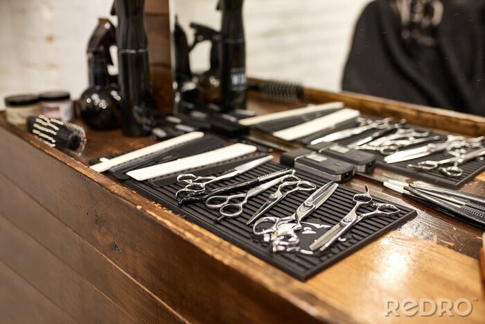 Tableau  barber tools on wooden shelf and mirror in barbershop