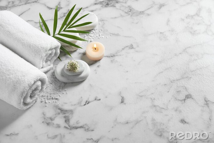 Tableau  Beautiful composition with spa stones on white marble table, above view