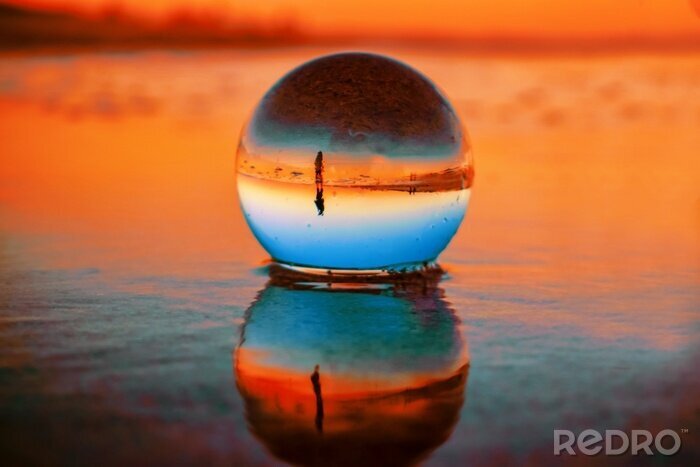 Tableau  Beautiful selective focus shot of a crystal ball reflecting the breathtaking sunset