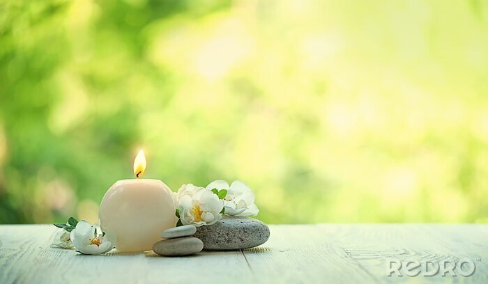 Tableau  beautiful tender scene with candle, flowers and stones. romantic still life. Relax still life with zen pebble stones, candle. spa wellness tranquil scene, soul equanimity calmnes concept. copy space