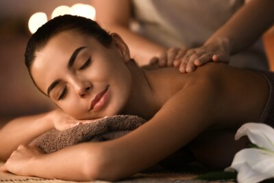 Tableau  Beautiful young woman receiving massage in spa salon
