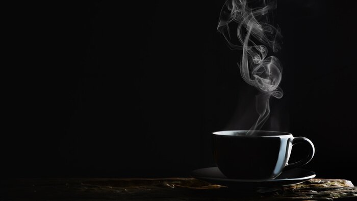 Tableau  beverage background of hot coffee, tea or chocolate in black cup on wooden plank in dark background