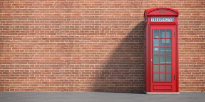Tableau  Cabine téléphonique rouge sur fond de mur de brique. Londres, symbole britannique et anglais. Espace pour le texte