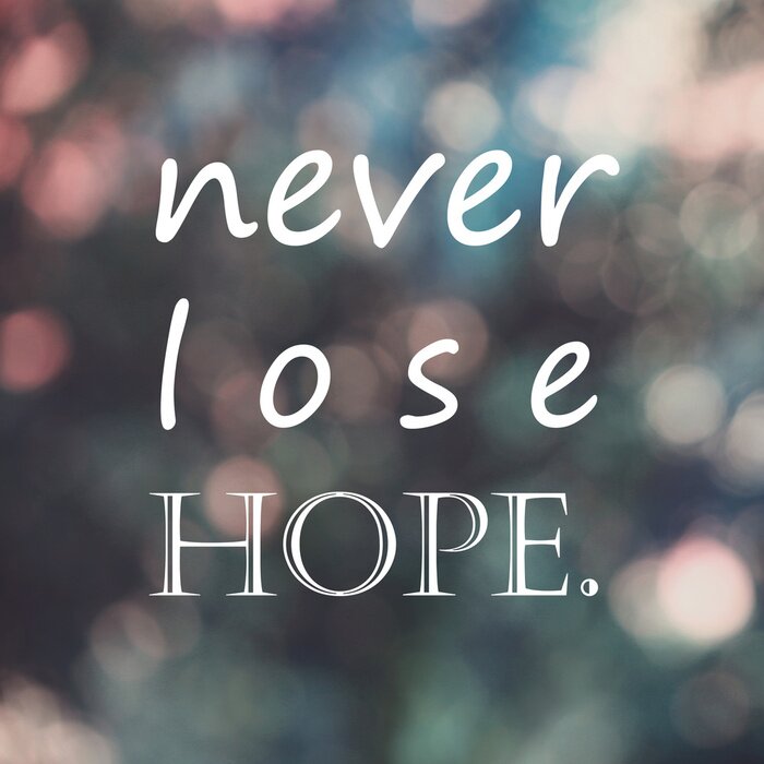 Tableau  Citation de vie de motivation de typographie, "ne jamais perdre l'espoir" sur fond de bokeh de flou, filtre de couleur