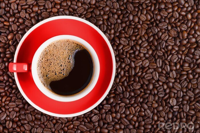 Tableau  coffee background of hot black coffee in red cup on roasted arabica coffee beans background