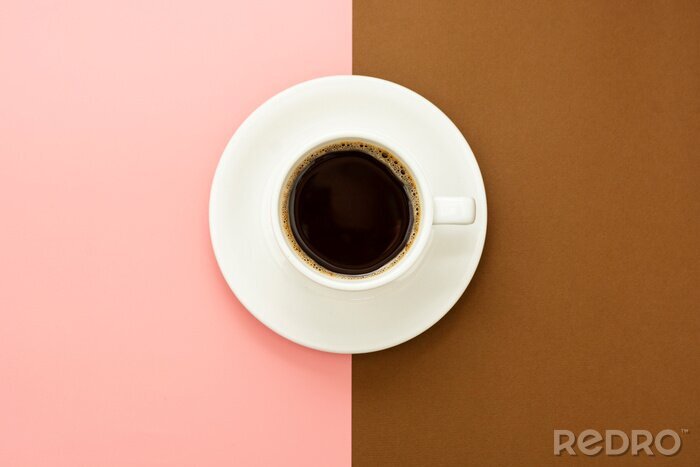 Tableau  Coffee cup isolated on brown and pink table. Top view, flat lay abstract black coffee drink with copy space.