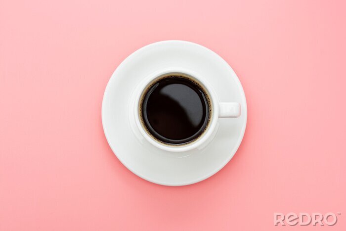 Tableau  Coffee cup isolated on pink table. Top view, flat lay abstract black coffee drink with copy space.
