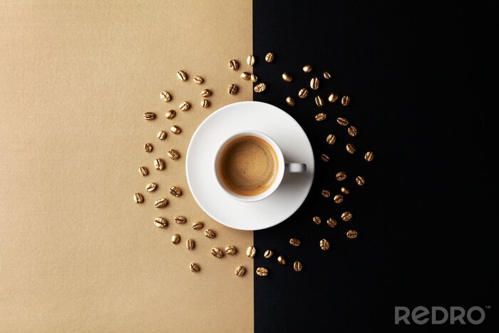 Tableau  Cup of coffee and coffee beans on gold black background. Creative flat lay. Top view.