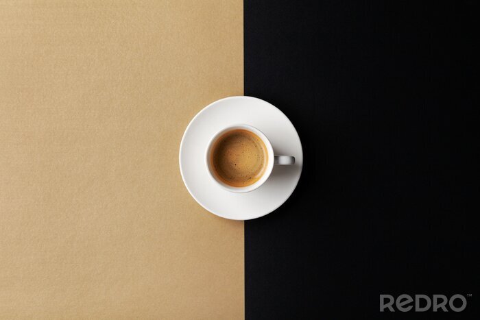 Tableau  Cup of coffee on gold black background. Minimalistic flat lay. Top view.
