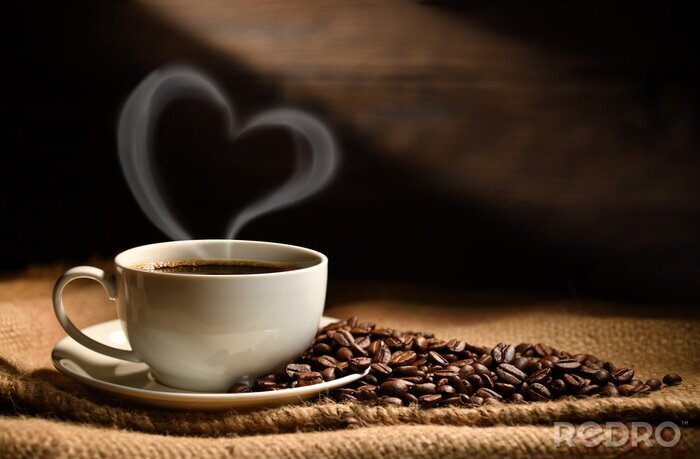 Tableau  Cup of coffee with heart shape smoke and coffee beans on burlap sack on old wooden background