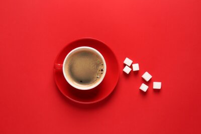 Cup of hot coffee and sugar on color background