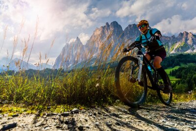 Tableau  Cycling outdoor adventure in Dolomites. Cycling woman in Dolomites landscape. Woman cycling MTB enduro trail track. Outdoor sport activity.