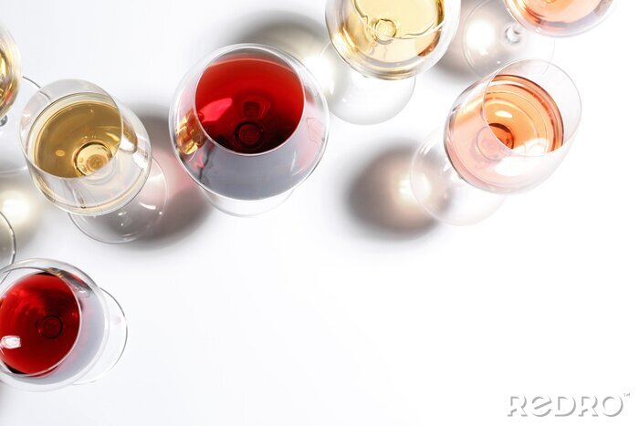 Tableau  Different glasses with wine on white background, top view